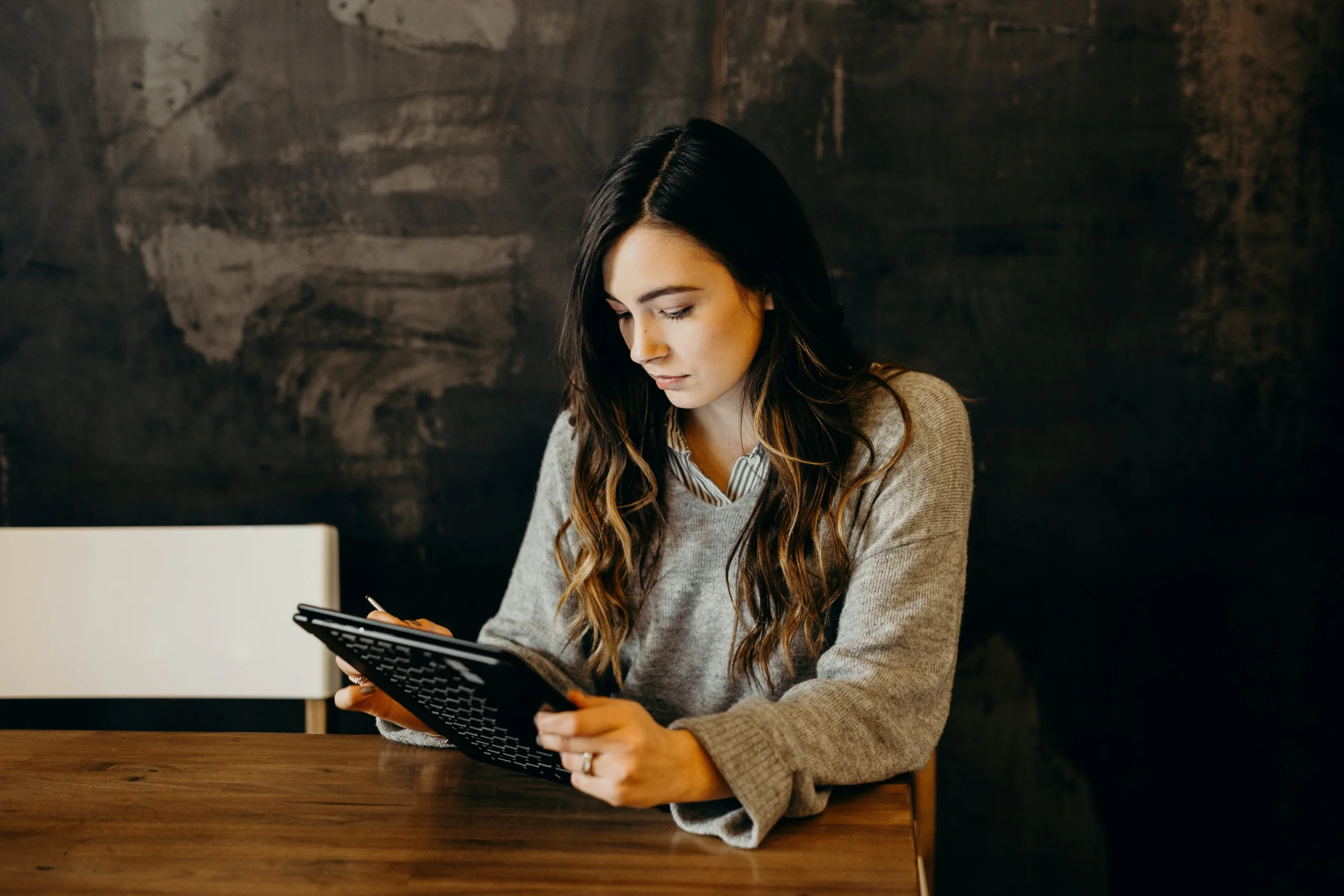 ISO manager working through a self-paced PECB course on a tablet at a desk